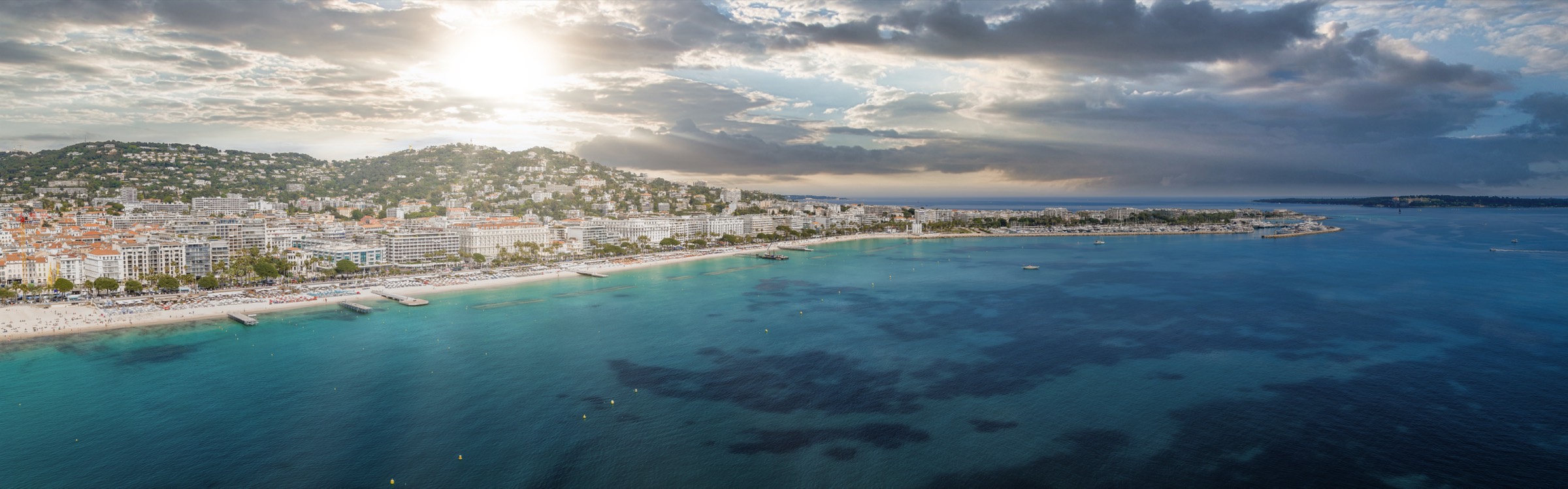 Aerial view of La Croisette and the bay at Cannes, where Volando Partners was born over a beer by the Mediterranean